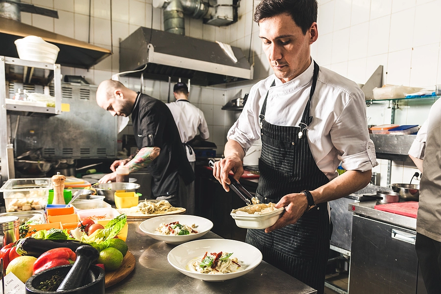 Chef cooking in clean restaurant kitchen environment